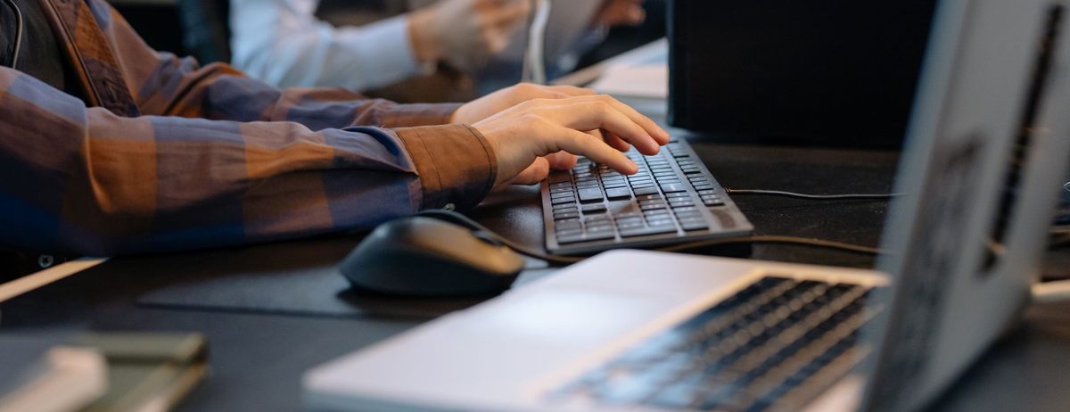 A billing team member working through claims on a laptop.