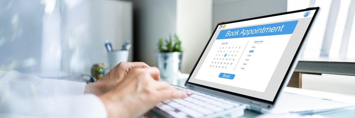 A patient booking an appointment themselves on a laptop.