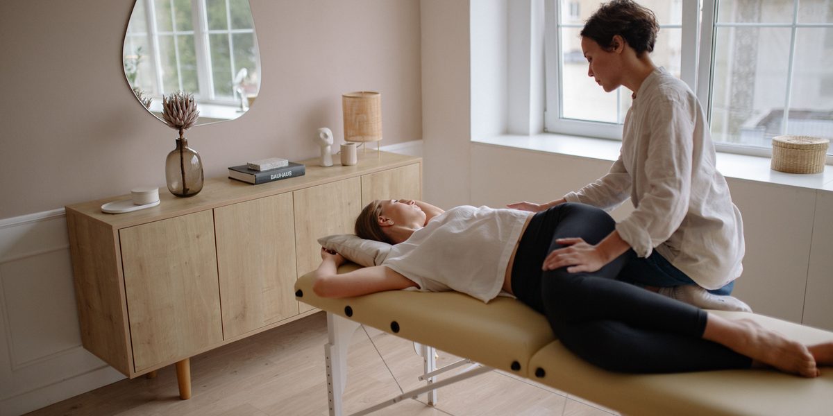 A chiropractor working with a patient on the treatment table.