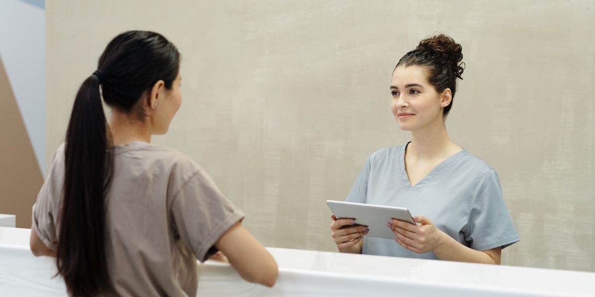 A patient settling up at the front desk on the way out.